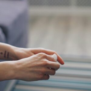 Close-up of hands during therapy session, symbolizing mental health support.